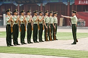 Soldiers with rifles and bayonets on parade in the Forbidden City.