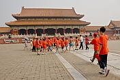 Chinese school-children in orange teeshirts visit Gate of Supreme Harmony at the Forbidden City.