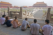 A group of Chinese art students draw tourists at the Hall of Supreme Harmony in the Forbidden City.