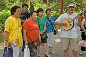 Chinese passers-by stop to join in the Sunday singing at Jingshan Park.