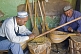 Two musical instrument makers in their craft workshop.