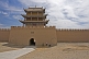 Two workers repair the paths in front of the main gateway to the Jiayuguan Fort.