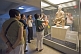 Image of Chinese and Western visitors admire a kneeling Terracotta Archer.