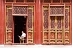 Image of Man reading paper at the Buddhist Temple of Sumeru Happiness and Longevity.