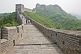 Image of Western and Chinese visitors walk along the Great Wall of China.