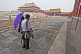 Two Chinese tourists visit the Forbidden City.