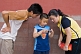 Image of Two Chinese tourists examine their son\\\\'s digital camera in the Forbidden City.