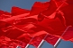 Image of Red flags billowing in the wind of Tiananmen Square.