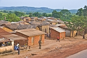 A small village of mud-brick houses next to the main road to Matadi.