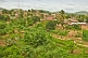 Image of Vegetable and banana plots across the river from brick and corrugated iron houses in central Boma.