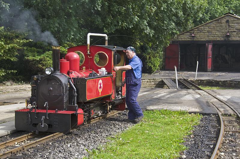 Locomotive driver prepares steam engine Fox at Kirklees Light Railway at Clayton West.