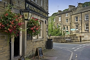 Elephant and Castle public house with hanging flower baskets on Lower Mill Lane Holmfirth.