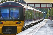 Electric train on platform ready to depart from railway station.