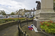 War Memorial with commemorative wreaths on roundabout in the High Street.