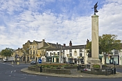 The War Memorial on a roundabout in the High Street is outside the Black Horse public house.