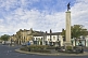 Image of The War Memorial on a roundabout in the High Street is outside the Black Horse public house.