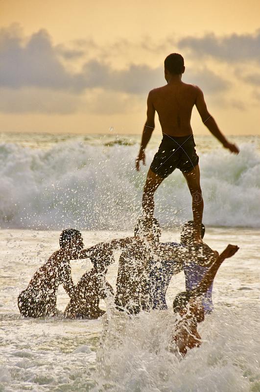 Indian boys playing into the surf