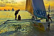 caption: Outrigger Perahu Beached At Dusk